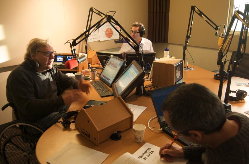 Cartoonist and journalist Joe Sacco signs a book for John Hockenberry after their interview.