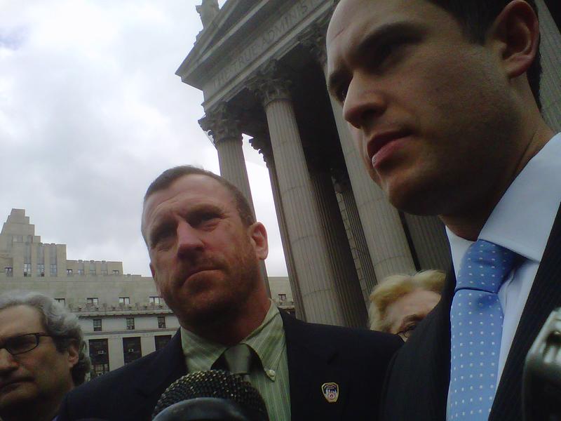 Attorneys Jack Lester (left) and Brett Joshpe flank Timothy Brown, a firefighter and the plaintiff in the lawsuit, outside State Supreme Court
