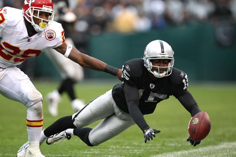 Johnnie Lee Higgins #15 of the Oakland Raiders misses a pass against Eric Berry #29 of the Kansas City Chiefs during an NFL game at Oakland-Alameda County Coliseum on November 7, 2010.
