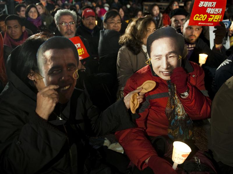 Anti-G20 protesters hold masks of U.S president Barack Obama and South Korea's President Lee Myung-bak as they gather on November 10, 2010 in central Seoul, South Korea.