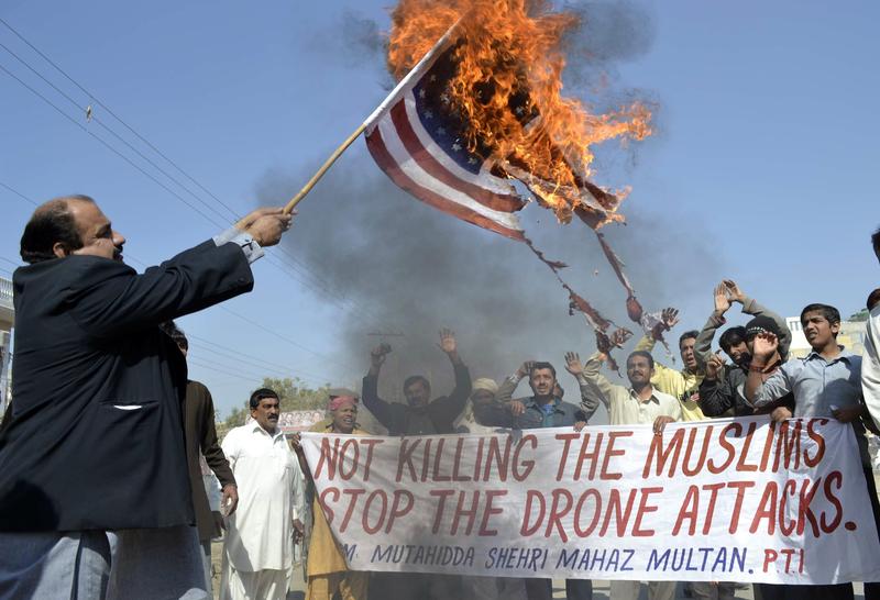 A Pakistani protester holds a burning US flag during a protest on February 9, 2012 against the US drone attacks in the Pakistani tribal region.