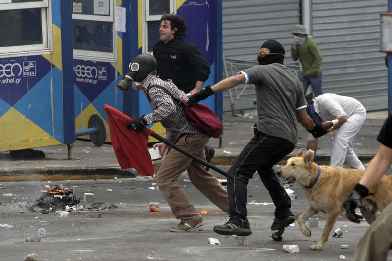 Protesters throw missles at Greek riot police as they clash on May 5, 2010 in Athens, Greece.