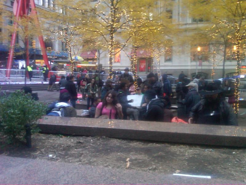 Brookfield Properties strings holiday lights in Zuccotti Park.