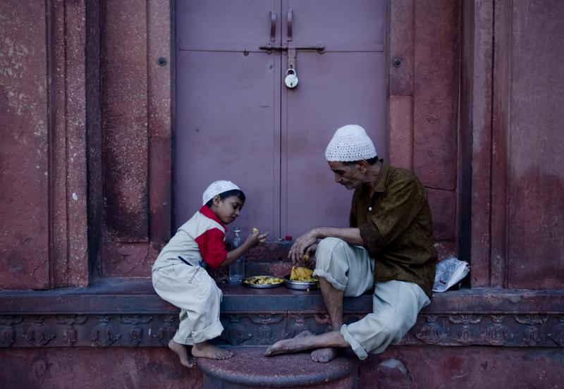 An Indian Muslim man and child break their fast on the first day of Ramadan at Jama Masjid mosque in New Delhi on August 12, 2010.