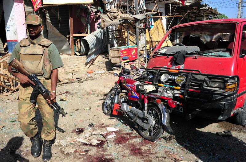 A Pakistani soldier stands guard at the site of a suicide and bomb attack outside the Frontier Constabulary main training center in Shabqadar town on May 13, 2011