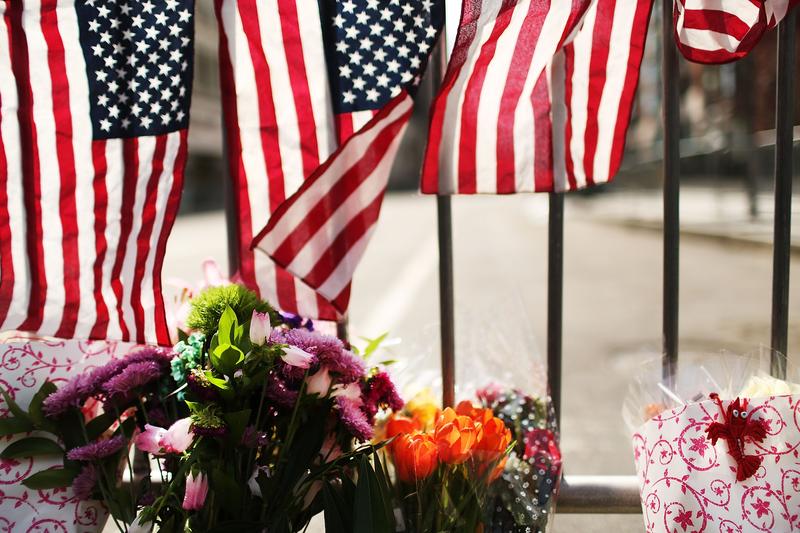 Flowers are left at a security gate near the scene of yesterday's bombing attack at the Boston Marathon on April 16, 2013 in Boston, Massachusetts.