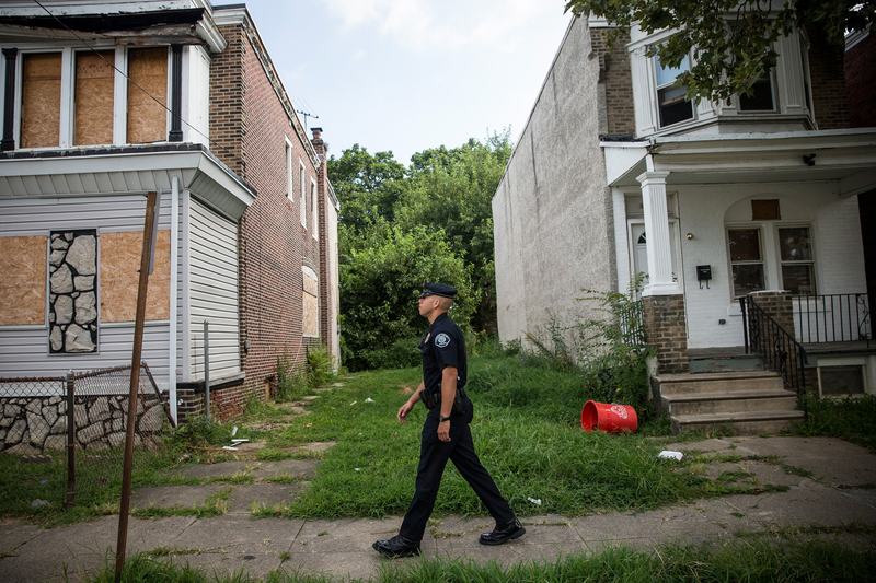 Officer Adam Fulmore, of the Camden County Police Department, goes on a foot patrol on August 22, 2013 in the Parkside neighborhood of Camden, New Jersey.