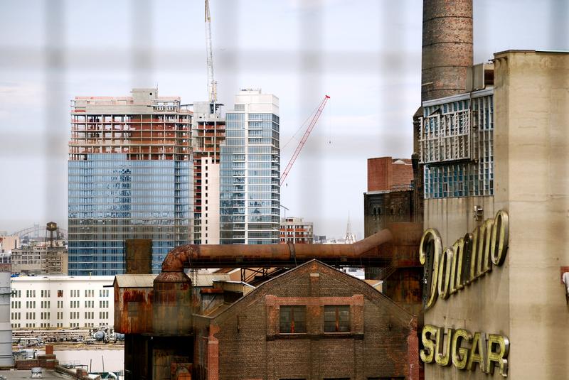 The now defunct Domino Sugar Factory in Williamsburg, Brooklyn, with a new condo rising up to the north.