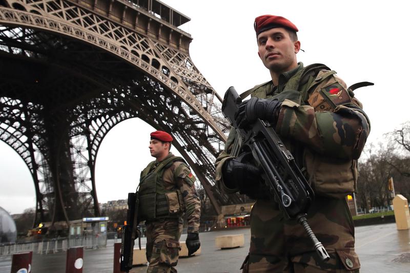 Armed security patrols around the Eiffel Tower on January 9, 2015 in Paris, France.