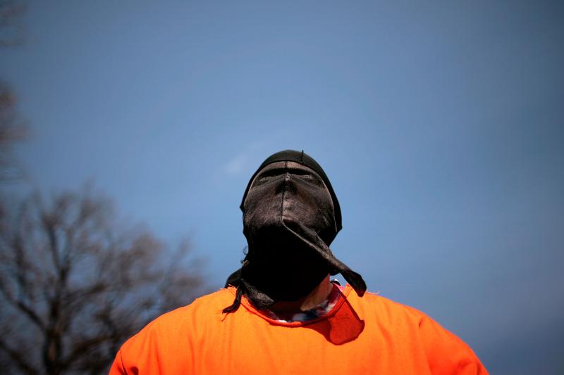 A demonstrator dresses as a 'detainee' during a rally to 'demand Congressional action to stop torture' by The Washington Region Religious Campaign Against Torture on Capitol Hill March 10, 2008.