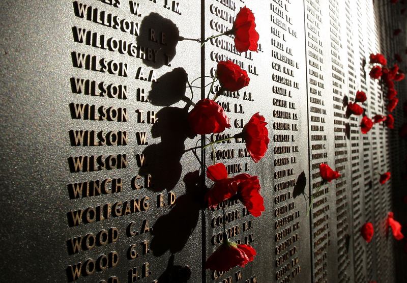 Poppies are placed beside the names of those who lost their lives on the Roll of Honour for World War I after the ANZAC Day Dawn Service at the Australian War Memorial on April 25, 2008.