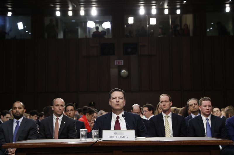 Former FBI director James Comey listens to the committee chairman at the beginning of the Senate Intelligence Committee hearing on Capitol Hill, Thursday, June 8, 2017, in Washington.
