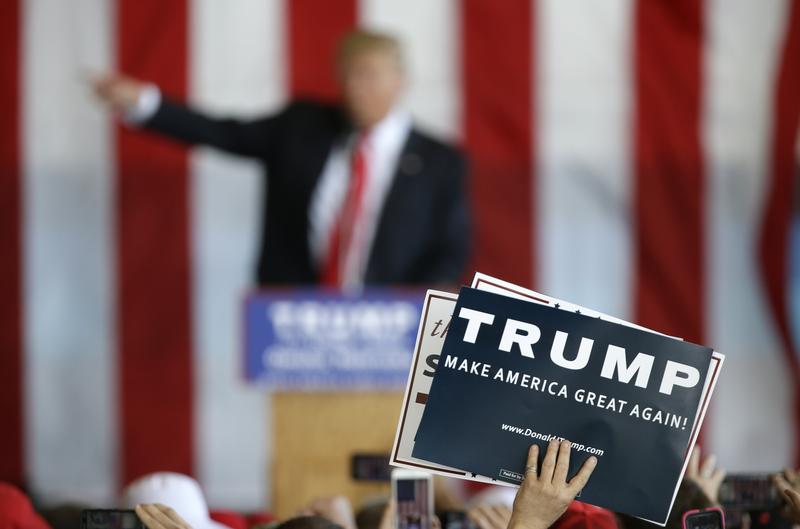 A supporter holds a sign as Republican presidential candidate Donald Trump speaks at a rally, Friday, May 6, 2016, in Omaha, Neb.