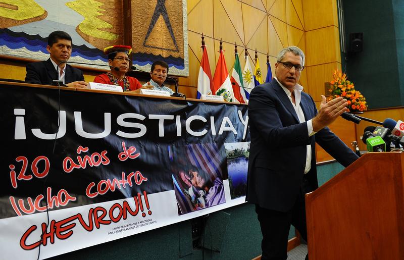 Steven Donziger gestures during a press conference in Quito, Ecuador.