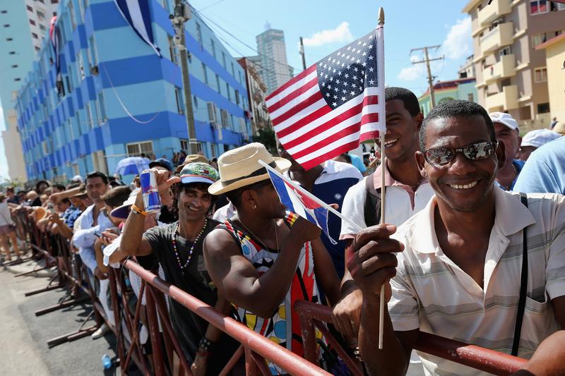 Hundreds of Cubans and visitors from other countries gather across the street from the newly reopened U.S. Embassy to observe the flag-raising ceremony August 14, 2015 in Havana, Cuba.