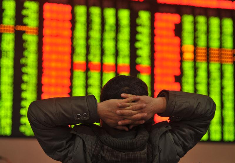 An investor looks at prices at a firm in China on January 4, 2016.