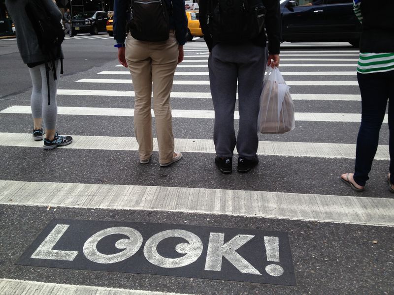 Look! Crosswalk sign urging pedestrians to pay attention