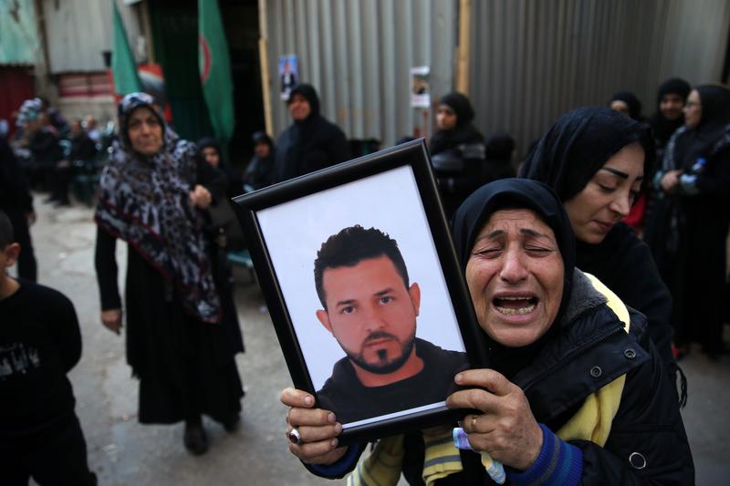 A relative of Samer Huhu, who was killed in a twin bombing attack that rocked a busy shopping street in the area of Burj al-Barajneh in southern Beirut, mourns him during his funeral.