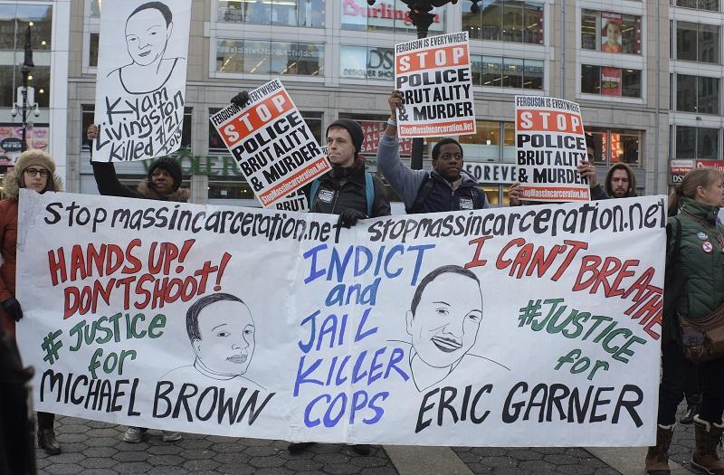 NEW YORK CITY - JANUARY 19 2015: several hundred activists gathered at Union Square Park prior to starting the Four Mile March on Martin Luther King's birthday. Eric Garner, Michael Brown banner