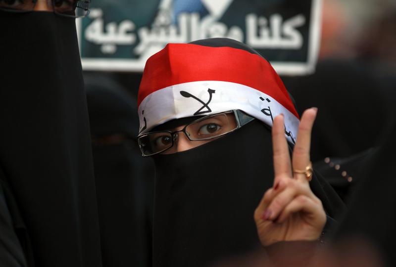A Yemeni woman flashes the V-sign for victory during a rally commemorating the second anniversary of a major clash between opposition protesters against former Yemeni president Ali Abdullah Saleh.