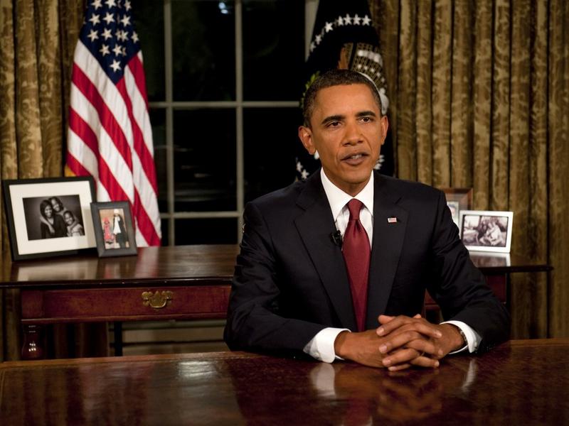 President Barack Obama reads his speech to photographers after delivering an address to the nation on the end of combat operations in Iraq from the Oval Office on August 31, 2010