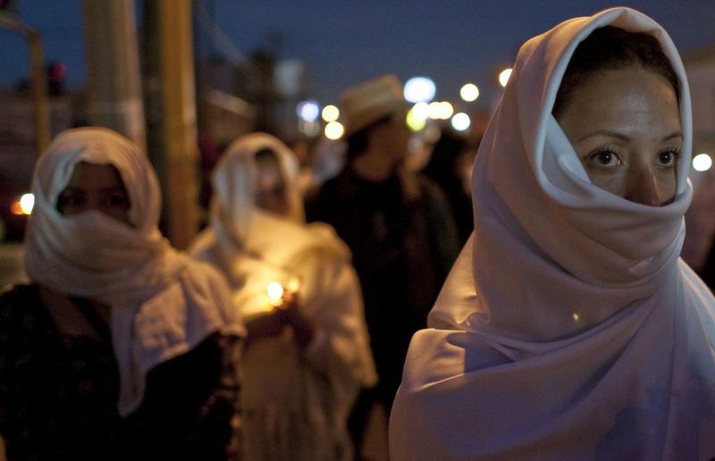 Women hold candles during a protest in Ciudad Juarez on December 22, 2010. About 500 people, mostly women, demonstrated outside the the Attorney General's Office to demand justice.