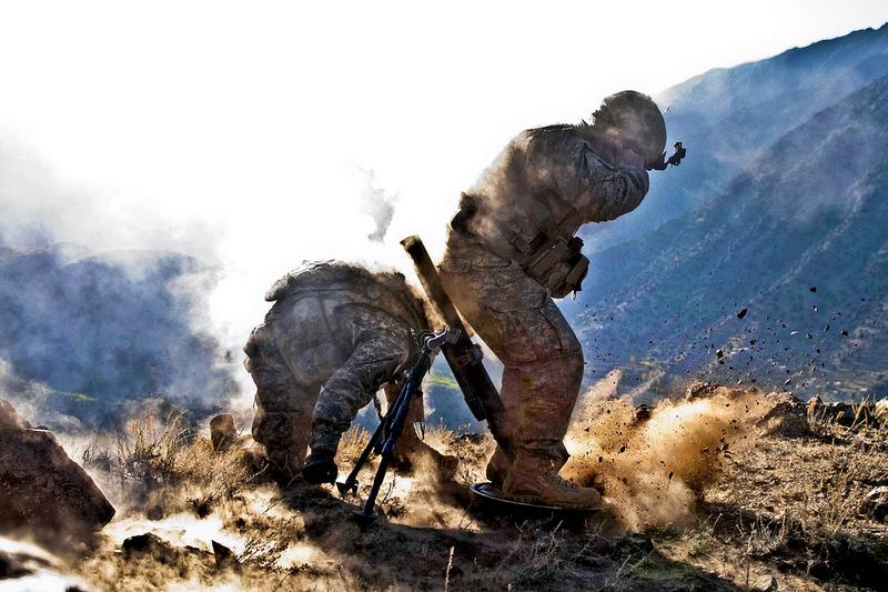 Sgt. Richard A. Darvial and Spc. Corey C. Canterbury fire a mortar in eastern Afghanistan Dec. 11.