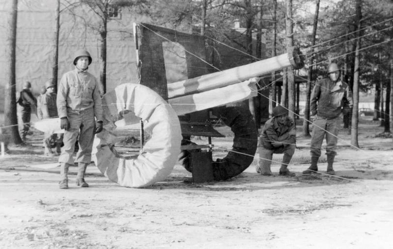 Soldiers in the 603rd assembling an improvised wooden dummy.