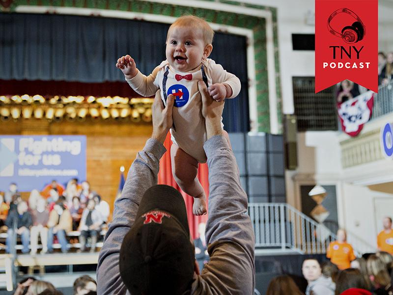 Attendee Grant Sorrell holds up his son ahead of an event with Warren Buffett, chairman and chief executive officer of Berkshire Hathaway Inc., not pictured, and Hillary Clinton, former Secretary of S