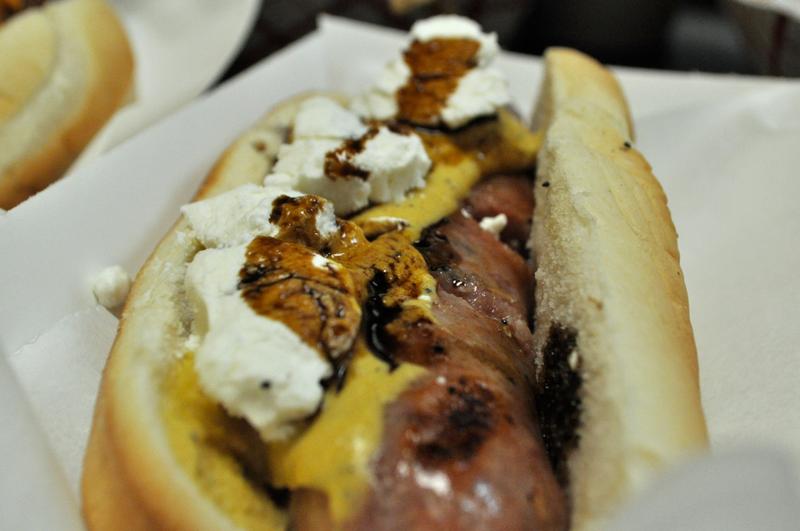 Truffle pork sausage with sauce moutarde, goat cheese, and truffle balsamic drizzle.