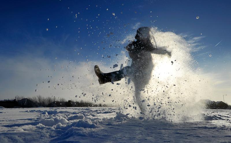 Archie Kirk plays in the snow as his school remains closed after the heavy snow of the last few days, in Brighton, southern England on December 3, 2010.