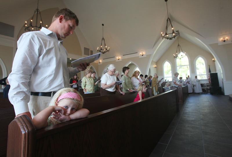Worshipers gather inside Christ Episcopal Church, which was completely destroyed by Hurricane Katrina and rebuilt, April 17, 2011 in Waveland, Mississippi.