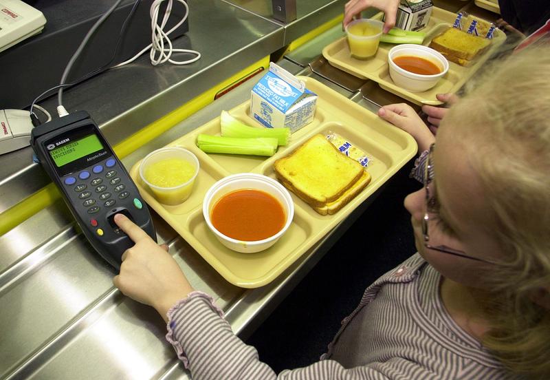 A student uses a fingerprint scanner to pay for lunch at an elementary school.