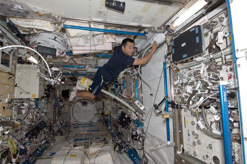 Japan Aerospace Exploration Agency astronaut Aki Hoshide, uses a vacuum cleaner during housekeeping operations in the Kibo laboratory of the International Space Station July 28, 2012 in Space.