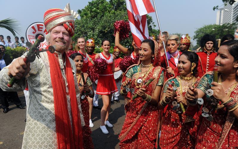 British business tycoon Richard Branson performs a traditional Lezim dance during a photo opportunity parade in Mumbai on October 26, 2012