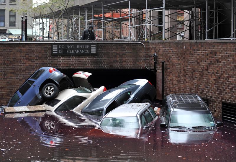 Cars piled on top of each other at the entrance to a garage on South Willliam Street in Lower Manhattan October 31, 2012 in New York as the city begins to clean up after Hurricane Sandy.