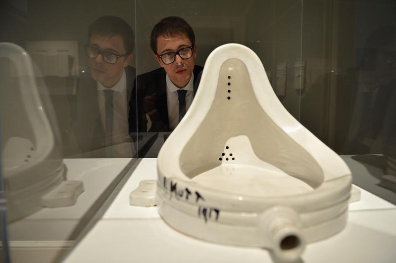 A gallery assistant views 'Fountain Marcel Duchamp' at The Scottish National Gallery of Modern Art on December 14, 2012 in Edinburgh, Scotland.