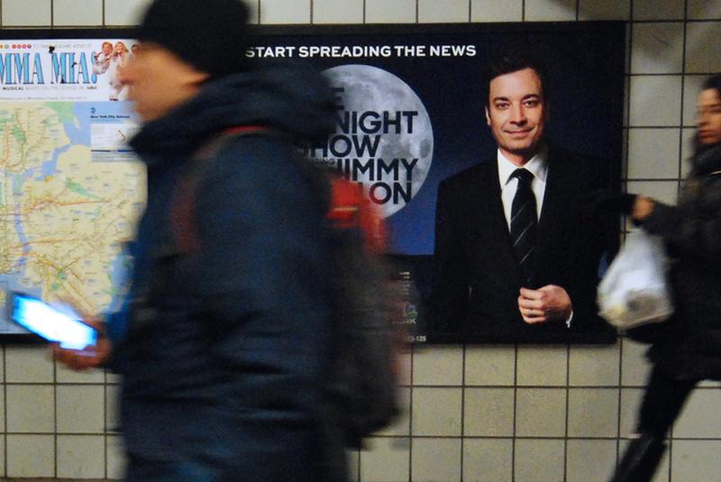 A poster announcing the premiere of The Tonight Show with Jimmy Fallon hangs in the 42nd/Port Authority subway station.