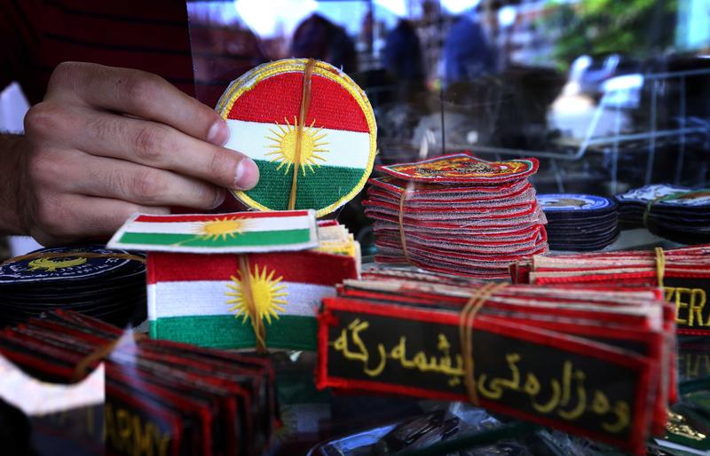 An Iraqi man displays military badges at a shop in Arbil, the capital of the autonomous Kurdish region of northern Iraq.