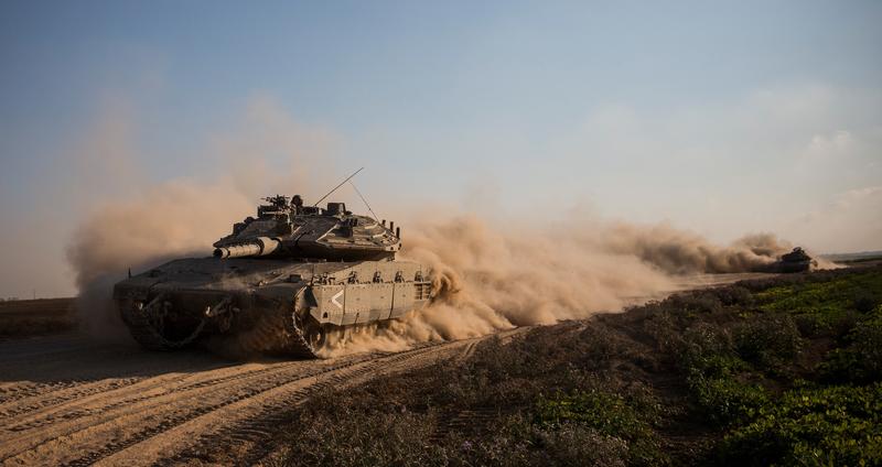 Israeli tanks change positions near the Israeli-Gaza border on July 23, 2014 near Kfar Aza, Israel. As operation 'Protective Edge ' enters its 16th day, 29 Israeli soldiers have been killed and over