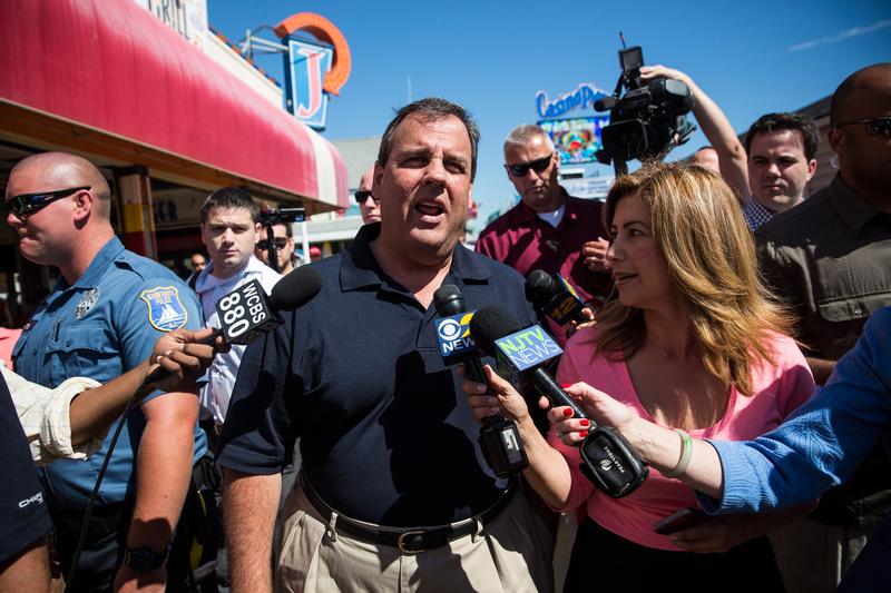 New Jersey Governor Chris Christie takes questions from the media while touring the boardwalk in Seaside Heights, New Jersey.