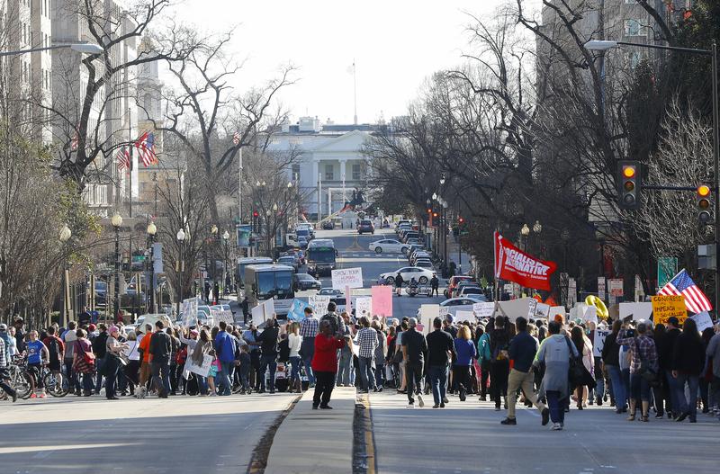 Demonstrators march downtown toward the White House during a rally in Washington on Feb. 20, 2017.