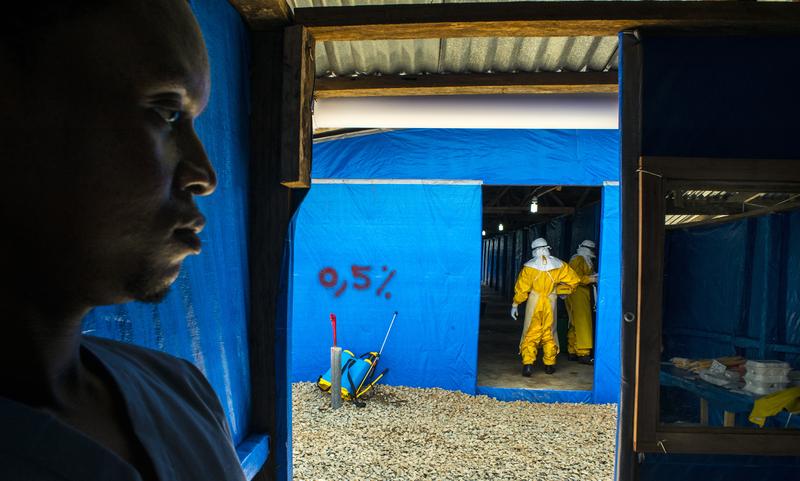 James Momoh stands by as colleagues enter the suspected ebloa case ward Bong County Ebola Treatment Unit, on Tuesday September 16, 2014.
