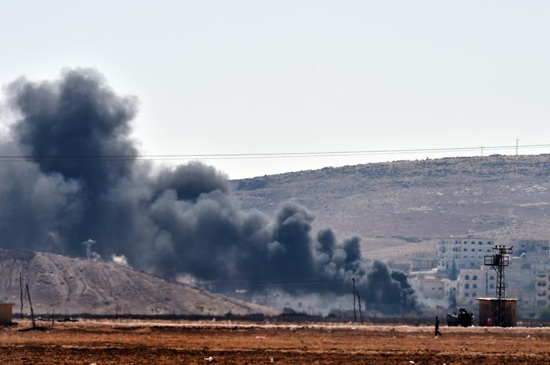 Smoke rises from the Syrian town of Ain al-Arab, known as Kobani by the Kurds, on the Turkish-Syrian border on October 6, 2014.