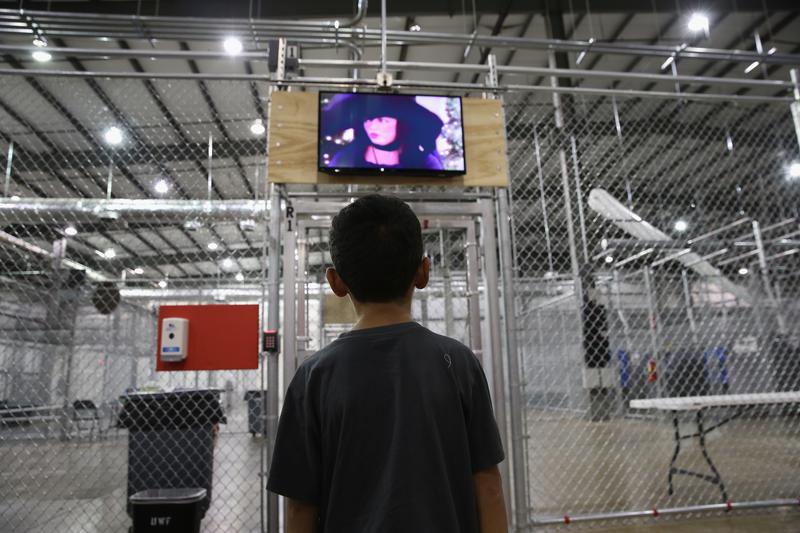boy from Honduras watches a movie at a detention facility run by the U.S. Border Patrol on September 8, 2014 in McAllen, Texas.