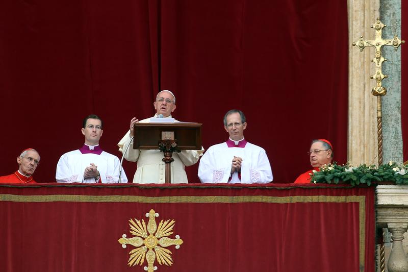 Pope Francis delivers his Christmas Day message from the central balcony of St Peter's Basilica on December 25, 2013 in Vatican City, Vatican.