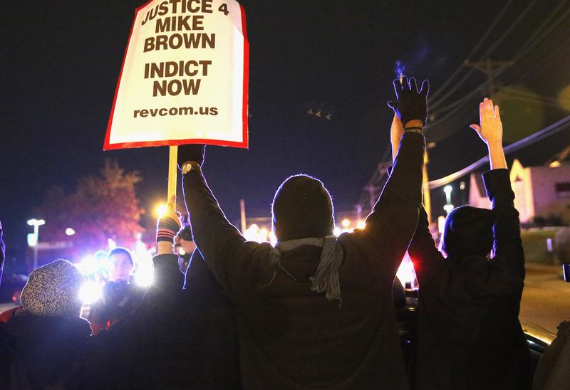 Demonstrators are confronted by police as they block a street during a protest ahead of the grand jury announcement on November 24, 2014 in Ferguson, Missouri.