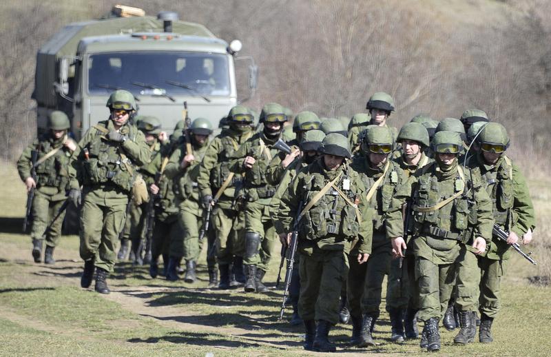 Armed military men block access to a Ukrainian border on March 3, 2014.
