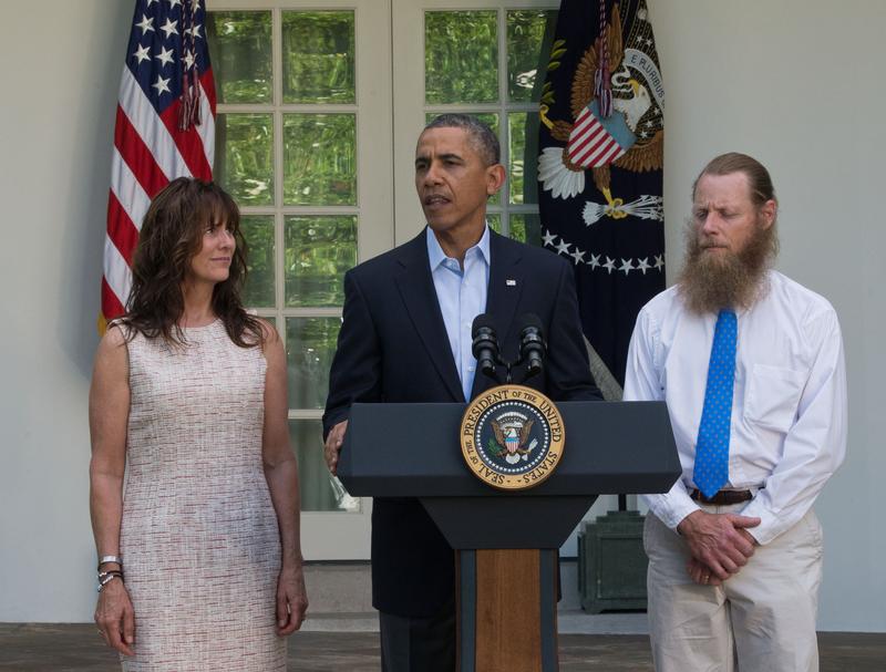 President Barack Obama makes a statement about the release of Sgt. Bowe Bergdahl as his parents, Jani Bergdahl (L) and Bob Bergdahl (R) listen May 31, 2014 in the Rose Garden at the White House.