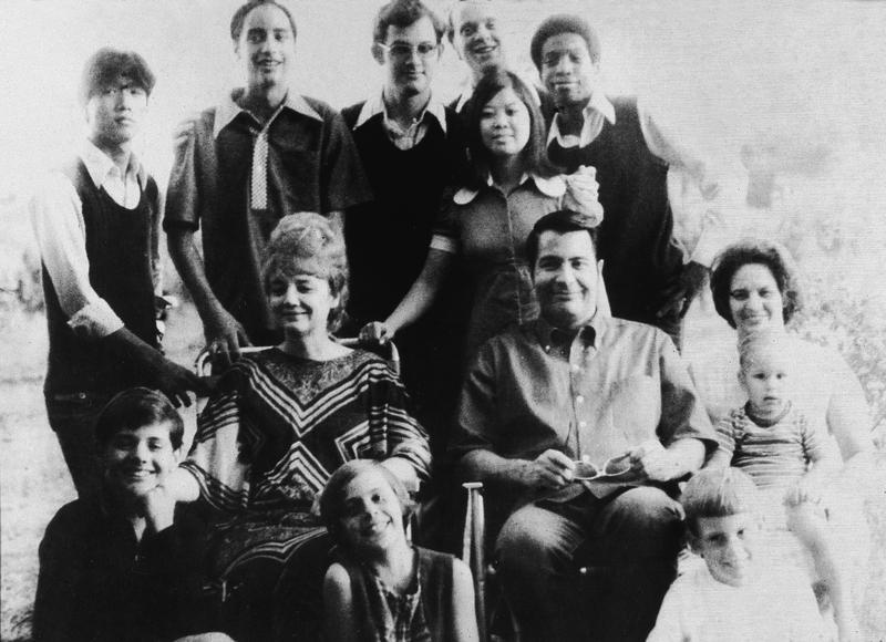 Portrait of American religious leader Jim Jones (1931 - 1978), the founder of the People's Temple, and his wife, Marceline Jones (1927 - 1978), seated in front of their adopted children.